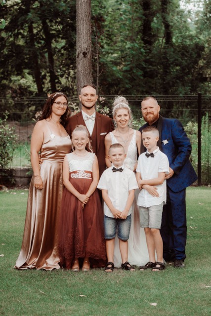 Photo de groupe prise en extérieur lors d’un mariage à Lyon, capturée par Ned Photographie. Un souvenir précieux de famille et d’amis réunis.