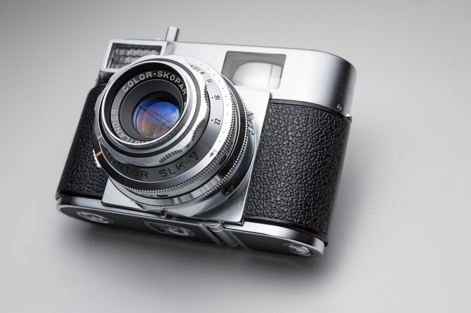 Close-up of a classic vintage analog camera with leather grip and Color-Skopar lens.