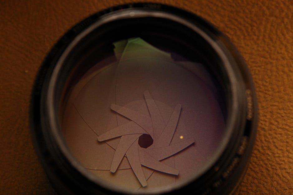 Detailed view of a camera lens showing the aperture blades in a spiral formation.