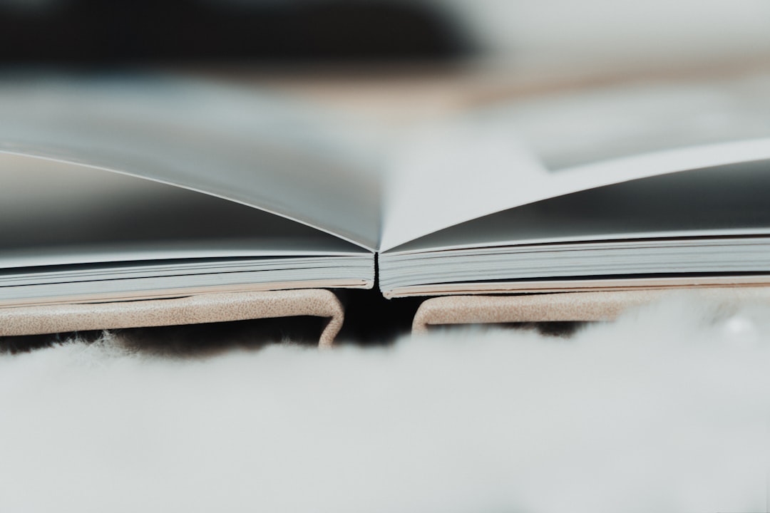 an open book sitting on top of a fluffy white blanket