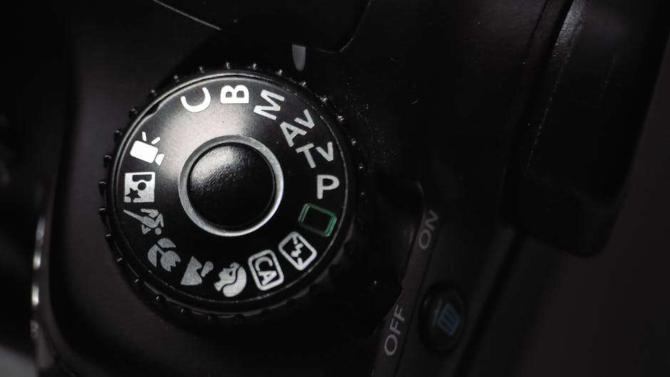 Detailed close-up of a DSLR camera mode dial showing various settings.