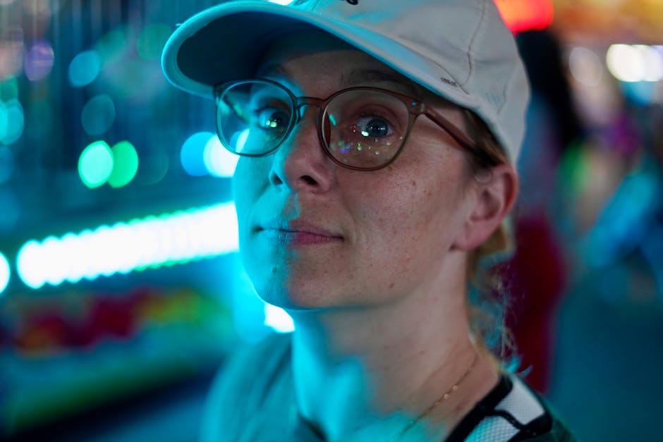A thoughtful person at a vibrant night fair in Tampa, FL with colorful bokeh.