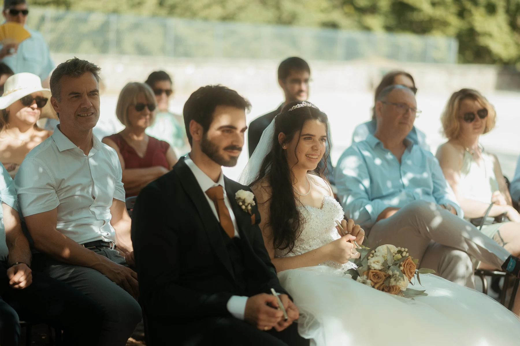Mariés assis au premier rang cérémonie en plein air lumière estivale, mariage au Oullins-Pierre-Bénite