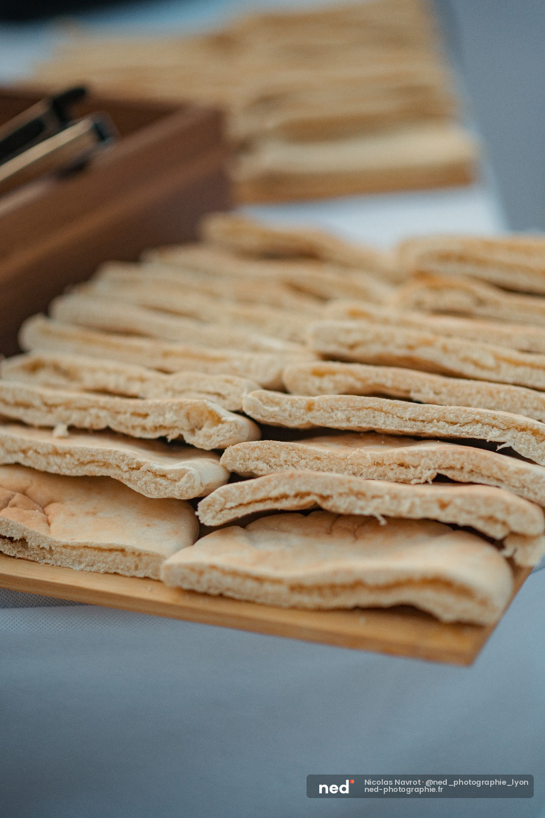 Biscuits fins et croustillants alignés sur une planche en bois, couteau en arrière-plan, lumière naturelle